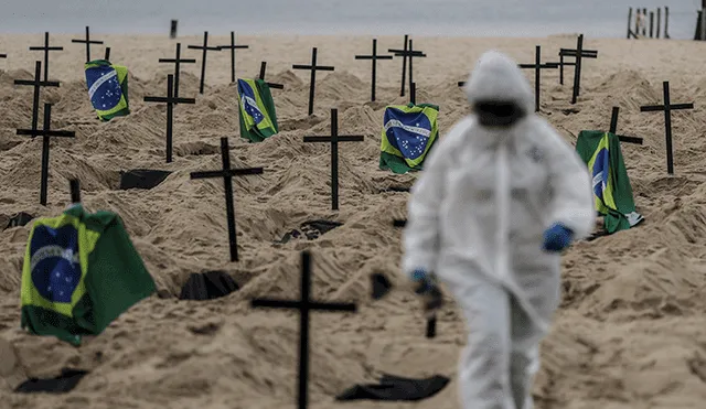 Activistas colocan cientos de cruces durante un acto organizado por la ONG Rio de Paz en la playa de Copacabana, Río de Janeiro (Brasil). | Foto: Antonio Lacerd / EFE