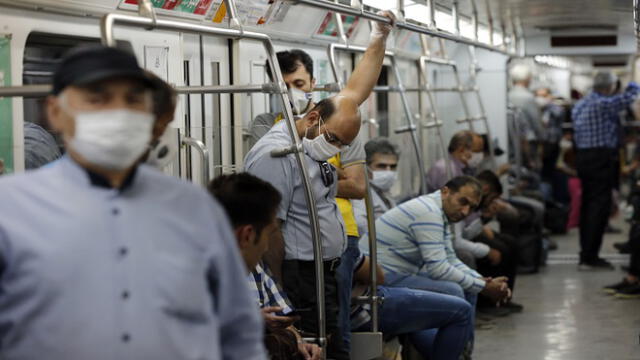 Iranians, mostly wearing face masks, are pictured in a train carriage at a metro station in the capital Tehran on June 10, 2020 amid the coronavirus Covid-19 pandemic crisis. - Nearly one in five Iranians may have been infected with the novel coronavirus since the country's outbreak started in February, a health official said yesterday. The figure represents 18.75 percent of the more than 80 million population of Iran, which on June 9 announced another 74 deaths from the coronavirus. (Photo by STRINGER / AFP)