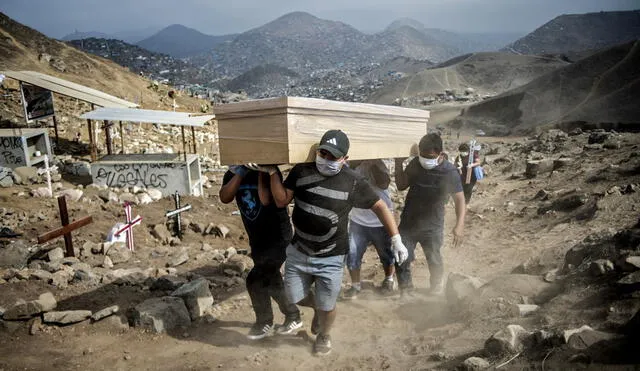 Relatives carry the coffin of a suspected COVID-19 victim at the Nueva Esperanza cemetery, one of the largest in Latin America, in the southern outskirts of Lima on May 30, 2020. (Photo by Ernesto BENAVIDES / AFP)