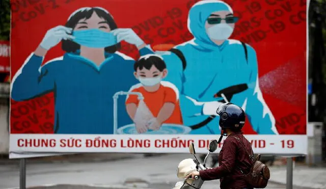 Propaganda oficial en Hanoi para que la población utilice, de manera obligatoria, los tapabocas. Foto: EFE