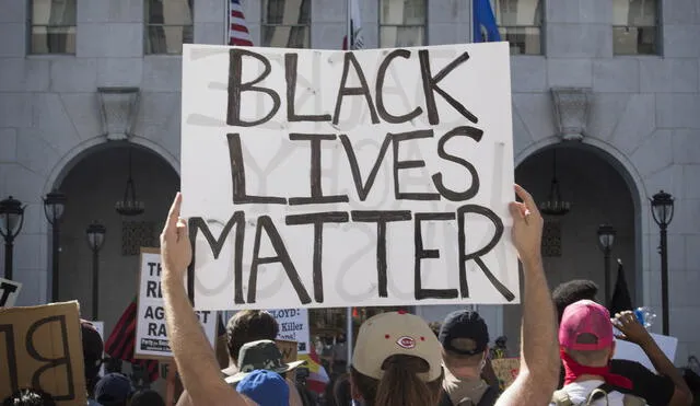 Supporters of Black Lives Matter, hold signs during a protest outside the Hall of Justice as they demonstrate against the death of George Floyd, in Los Angeles, California on June 10, 2020. (Photo by Mark RALSTON / AFP)