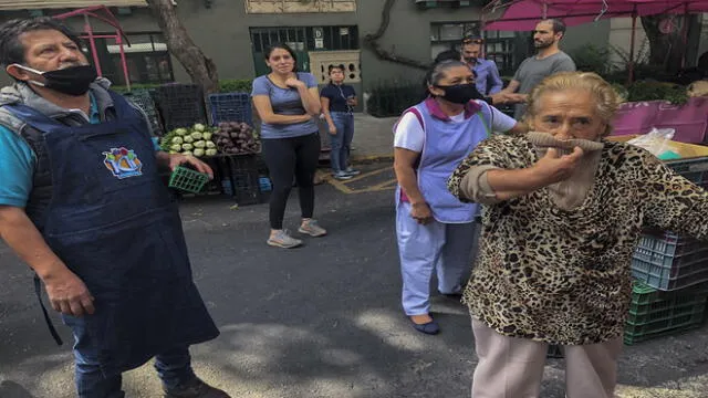 People react during a quake at an open market in Mexico City, on June 23, 2020. - A 7.1 magnitude quake was registered Tuesday in the south of Mexico, according to the Mexican National Seismological Service. (Photo by Pedro PARDO / AFP)