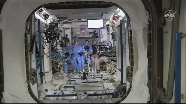 This NASA video frame grab image shows NASA SpaceX�s Crew Dragon astronauts Douglas Hurley(R) and Robert Behnken(2ndR) arriving after the hatch opened to the International Space Station, posing with other astronauts on May 31, 2020. - US astronauts on a SpaceX Crew Dragon capsule were completing final close out procedures before entering the International Space Station after the hatch was opened between the two vessels. The hatch opened at 1:02 pm Eastern Time (1702 GMT) as Bob Behnken and Doug Hurley were poised to cross over into the station, the first US astronauts to arrive on an American spacecraft in nine years. (Photo by Handout / NASA TV / AFP) / RESTRICTED TO EDITORIAL USE - MANDATORY CREDIT "AFP PHOTO /NASA TV/HANDOUT " - NO MARKETING - NO ADVERTISING CAMPAIGNS - DISTRIBUTED AS A SERVICE TO CLIENTS