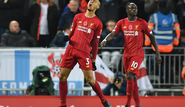 Liverpool's Brazilian midfielder Fabinho (L) celebrates after scoring the opening goal of the English Premier League football match between Liverpool and Manchester City at Anfield in Liverpool, north west England on November 10, 2019. (Photo by Paul ELLIS / AFP) / RESTRICTED TO EDITORIAL USE. No use with unauthorized audio, video, data, fixture lists, club/league logos or 'live' services. Online in-match use limited to 120 images. An additional 40 images may be used in extra time. No video emulation. Social media in-match use limited to 120 images. An additional 40 images may be used in extra time. No use in betting publications, games or single club/league/player publications. / 