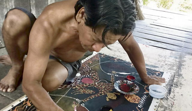 Santiago Yahuarcani pintando en una lanchama. Al lado, su visión del coronavirus.