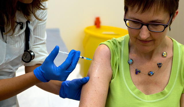 Clinical research fellow at Oxford University, Dr Felicity Hartnell, injects British volunteer Ruth Atkins with Ebola vaccine Chimp Adenovirus type 3 (ChAd3) at the Oxford Vaccine Group Centre for Clinical Vaccinology and Tropical Medicine (CCVTM) in Oxford on September 17, 2014. Atkins is the first person to receive the new vaccine for the Ebola virus after US President Barack Obama called for action against the epidemic and warned it was "spiralling out of control". The vaccine specifically targets the Zaire species of Ebola, which has killed 2,461 people out of 4,985 recorded cases in Guinea, Liberia, Senegal and Sierra Leone since the start of the year, according to World Health Organisation (WHO) data. AFP PHOTO/POOL/STEVE PARSONS (Photo by Steve Parsons / POOL / AFP)