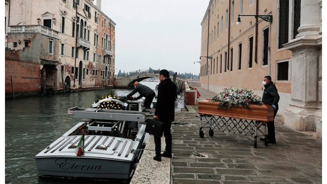 Empleados de una funeraria retiran un féretro de un hospital público en Venecia. (Foto: Marco Di Lauro)