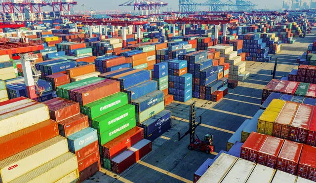 Containers are seen stacked at a port in Qingdao in China's eastern Shandong province on January 14, 2020. - China's trade surplus with the United States narrowed last year as the world's two biggest economies exchanged punitive tariffs in a bruising trade war, official data showed on January 14, on the eve of a deal to ease tensions. (Photo by STR / AFP)