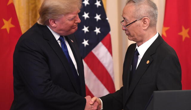 Chinese Vice Premier Liu He shakes hands with US President Donald Trump during a signing ceremony for trade agreement between the US and China in the East Room of the White House in Washington, DC, January 15, 2020. (Photo by SAUL LOEB / AFP)