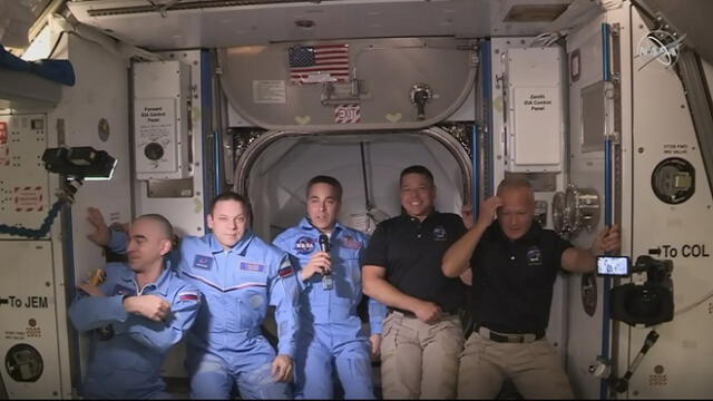This NASA video frame grab image shows NASA SpaceX�s Crew Dragon astronauts Douglas Hurley(R) and Robert Behnken(2ndR) arriving after the hatch opened to the International Space Station posing with other astronauts on May 31, 2020. - US astronauts on a SpaceX Crew Dragon capsule were completing final close out procedures before entering the International Space Station after the hatch was opened between the two vessels. The hatch opened at 1:02 pm Eastern Time (1702 GMT) as Bob Behnken and Doug Hurley were poised to cross over into the station, the first US astronauts to arrive on an American spacecraft in nine years. (Photo by Handout / NASA TV / AFP) / RESTRICTED TO EDITORIAL USE - MANDATORY CREDIT "AFP PHOTO /NASA TV/HANDOUT " - NO MARKETING - NO ADVERTISING CAMPAIGNS - DISTRIBUTED AS A SERVICE TO CLIENTS