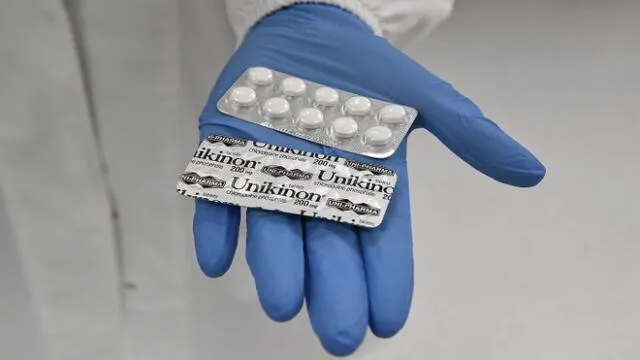 Unikinon chloroquine pills are seen in packaging at the Uni-pharma pharmaceutical company in a northern suburb of Athens, on June 5, 2020, where chloroquine pills are produced. - The company was able to activate an old license to manufacture this controversial drug, which in the 1990s was exported to Africa for the treatment of malaria. Despite the controversy, production and trials of chloroquine are carried on. The scientific community and public opinion are reeling from the withdrawal of the disputed study in the journal The Lancet on the use of chloroquine. But in Greece, where the manufacture of this drug resumed during the pandemic, the controversy is almost non-existent. (Photo by Louisa GOULIAMAKI / AFP)