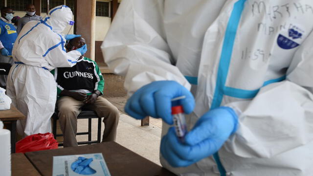 A Kenyan health worker takes a nasal swab from a resident of Eatstleigh, during a mass testing exercise for the COVID-19 coronavirus in Nairobi on May 20, 2020. (Photo by SIMON MAINA / AFP)