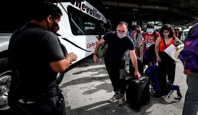 Varias personas esperan en una terminal de transporte para abordar un ómnibus este 4 de enero en Buenos Aires, mientras en la Argentina suben los casos de coronavirus. Foto: EFE