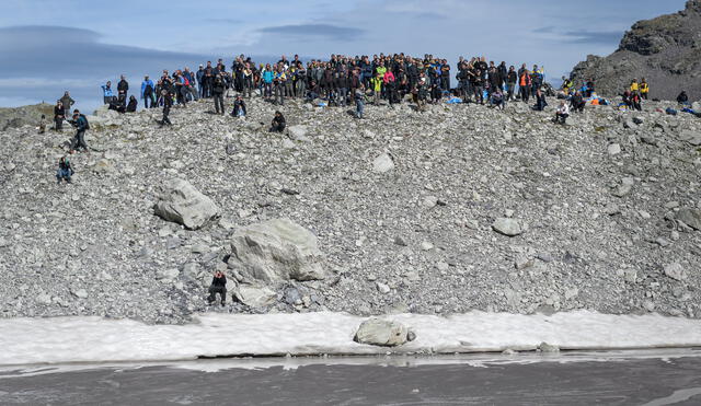 People take part in a symbolic farewell ceremony to mark the "death" of the Pizol glacier (Pizolgletscher) on September 22, 2019 above Mels, eastern Switzerland. - In a study released earlier this year, researchers of the ETH technical university in Zurich determined that more than 90 percent of Alpine glaciers will disappear by 2100 if greenhouse gas emissions are left unchecked. (Photo by Fabrice COFFRINI / AFP)