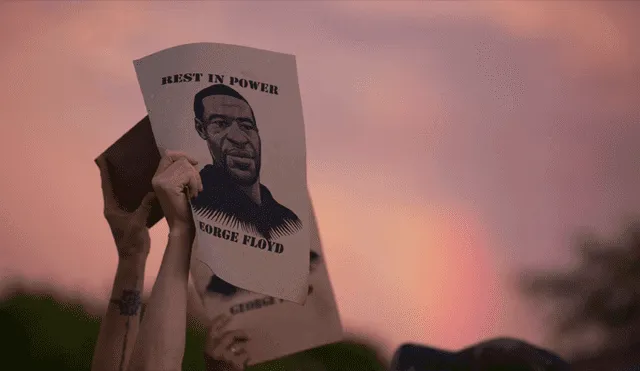 Un manifestante sostiene un cartel con una imagen de George Floyd durante las protestas en Mineápolis, Minnesota, el 27 de mayo. | Foto: Christine T. Nguyen /AP