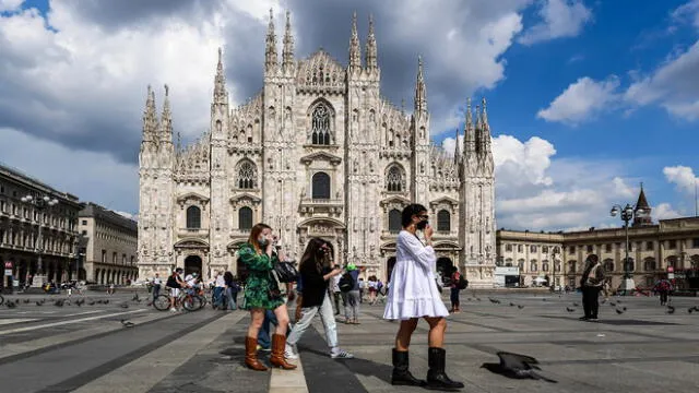 Young woman walk across Piazza del Duomo and the cathedral on June 3, 2020 in downtown Milan, as the country eases its lockdown aimed at curbing the spread of the COVID-19 infection, caused by the novel coronavirus. (Photo by Miguel MEDINA / AFP)