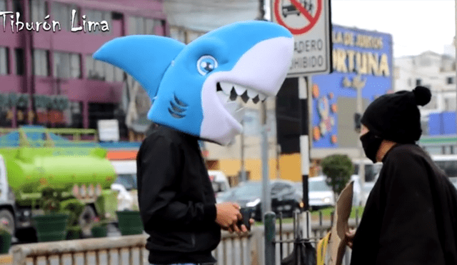 El joven, quien lleva la cabeza de un disfraz de tiburón, ayuda la gente que trabaja en la calle en plena pandemia. Foto: Tiburón Lima / Facebook