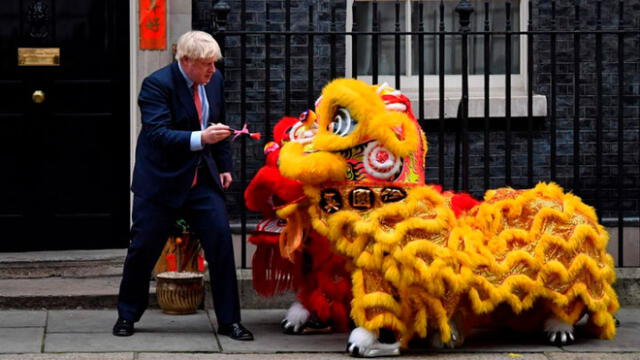 El primer ministro del Reino Unido, Boris Johnson, con un león chino en el marco del Año Nuevo Lunar. Foto: AFP