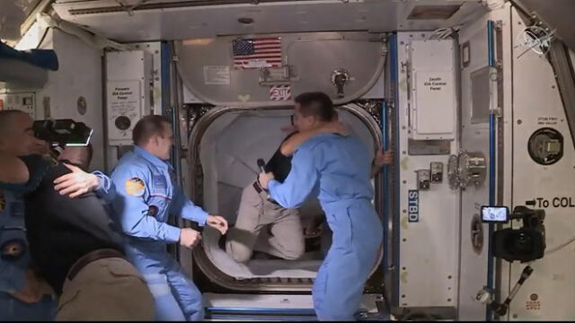 This NASA video frame grab image shows SpaceX�s Crew Dragon NASA astronauts Douglas Hurley(R) and Robert Behnken(L) arriving after the hatch opened to the International Space Station on May 31, 2020 with other astronauts. - US astronauts on a SpaceX Crew Dragon capsule were completing final close out procedures before entering the International Space Station after the hatch was opened between the two vessels. The hatch opened at 1:02 pm Eastern Time (1702 GMT) as Bob Behnken and Doug Hurley were poised to cross over into the station, the first US astronauts to arrive on an American spacecraft in nine years. (Photo by Handout / NASA TV / AFP) / RESTRICTED TO EDITORIAL USE - MANDATORY CREDIT "AFP PHOTO /NASA TV/HANDOUT " - NO MARKETING - NO ADVERTISING CAMPAIGNS - DISTRIBUTED AS A SERVICE TO CLIENTS