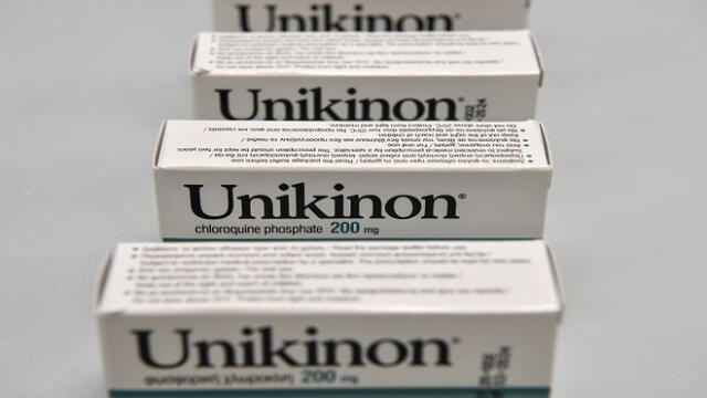 Packages of Unikinon chloroquine pills are seen at the Uni-pharma pharmaceutical company in a northern suburb of Athens, on June 5, 2020, where chloroquine pills are produced. - The company was able to activate an old license to manufacture this controversial drug, which in the 1990s was exported to Africa for the treatment of malaria. Despite the controversy, production and trials of chloroquine are carried on. The scientific community and public opinion are reeling from the withdrawal of the disputed study in the journal The Lancet on the use of chloroquine. But in Greece, where the manufacture of this drug resumed during the pandemic, the controversy is almost non-existent. (Photo by Louisa GOULIAMAKI / AFP)