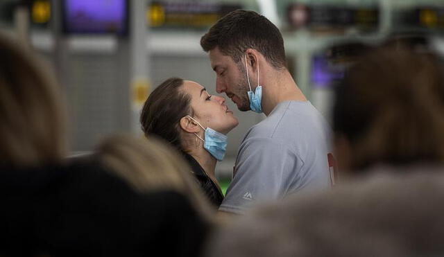 Pareja en aeropuerto de Barcelona se besa un día antes de que se decrete el estado de alarma en España. (Foto: Euronews)