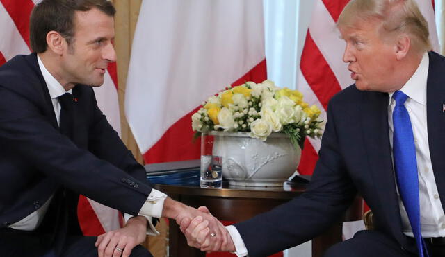 US President Donald Trump and France's President Emmanuel Macron shake hands during their meeting at Winfield House, London on December 3, 2019. - NATO leaders gather Tuesday for a summit to mark the alliance's 70th anniversary but with leaders feuding and name-calling over money and strategy, the mood is far from festive. (Photo by ludovic MARIN / POOL / AFP)
