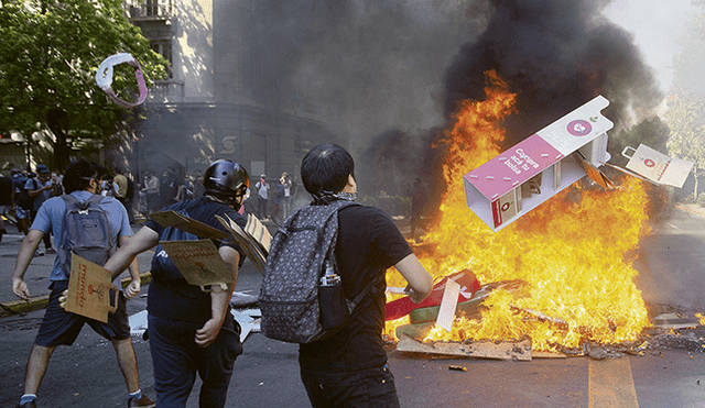 Hoguera. Jóvenes arman barricadas de fuego en una de las calles de Santiago.