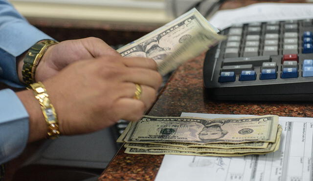 En Venezuela, un país sumido en grave crisis, gran cantidad de personas revisan el precio del dólar del Banco Central de Venezuela. Foto: AFP