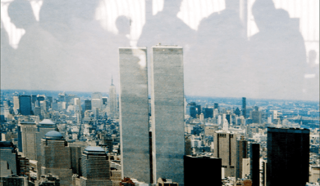 Varias personas se reflejan en una fotografía de las torres gemelas en el mirador del Empire State en Nueva York. Foto: EFE