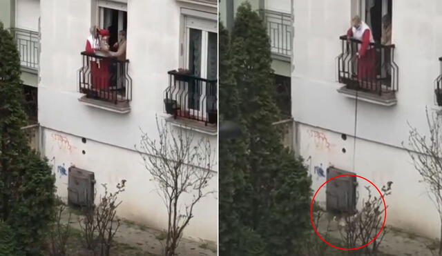 Desde el balcón, la señora baja a su perrito con un arnés hasta la calle para que este pueda caminar y respirar un poco. Foto: captura de YouTube