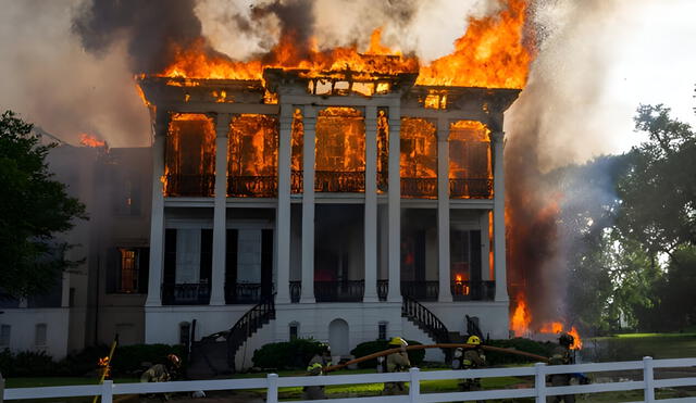 Firefighters battle intense flames as a historic Louisiana antebellum mansion succumbs to a devastating blaze, highlighting the urgent need for cultural preservation. Photo: Michael Johnson