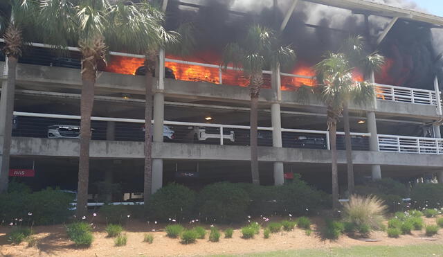 Firefighters work to extinguish flames engulfing the Jacksonville International Airport parking garage, causing major travel disruptions and raising safety concerns. Photo: Yahoo News Firefighters work to extinguish flames engulfing the Jacksonville International Airport parking garage, causing major travel disruptions and raising safety concerns. Photo: Yahoo News