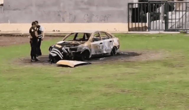 Efectivos de la Policía inspeccionan al auto quemado. Foto: redes CID Noticias    