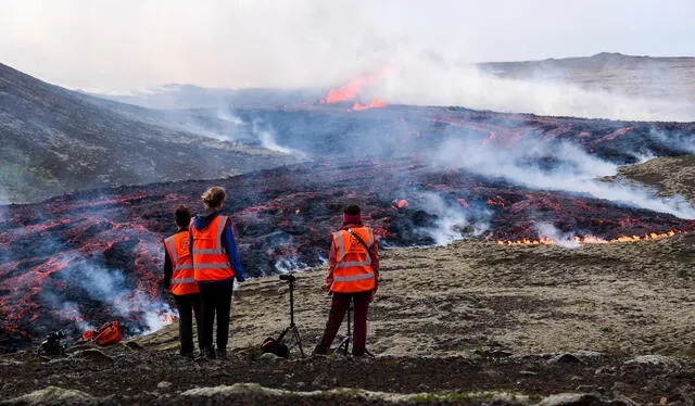 Observadores de la Universidad de Islandia frente al humo que emana la erupción volcánica cerca de Litli Hrutur. Foto: AFP   