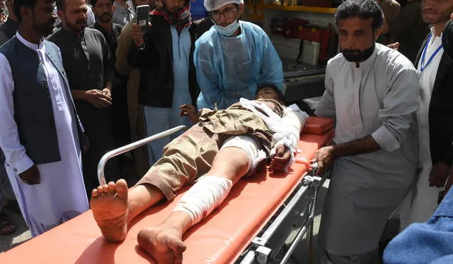 Personal médico y voluntarios transportan en una camilla a una víctima de una explosión en una mezquita en Pakistán. Foto: AFP   