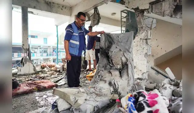 Un miembro de las Naciones Unidas muestra los rastros de sangre de las personas que descansaban cundo ocurrió el ataque de Israel a una escuela de Gaza. Foto: AFP   