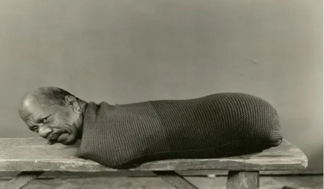  El "hombre oruga" antes de sus presentaciones sobre una tabla de madera. Fuente: anónimo   