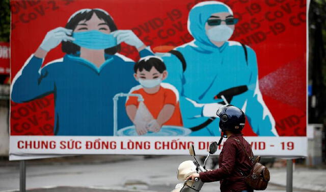Propaganda oficial en Hanoi para que la población utilice, de manera obligatoria, los tapabocas. Foto: EFE