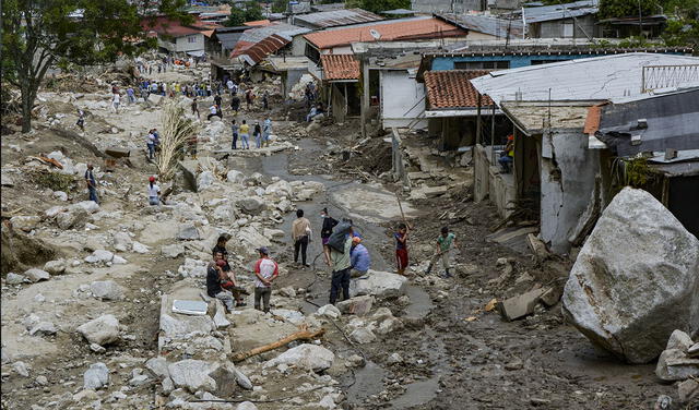 Residentes se ven en un área donde varias viviendas fueron destruidas por un deslizamiento de tierra causado por fuertes lluvias en la comunidad Valle del Mocoties, municipio de Tovar, estado de Mérida, Venezuela