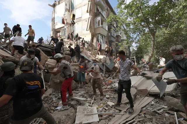 Voluntarios y personal de rescate retiran los escombros de un edificio residencial destruido tras un ataque con misiles en Kiev. Foto: AFP   