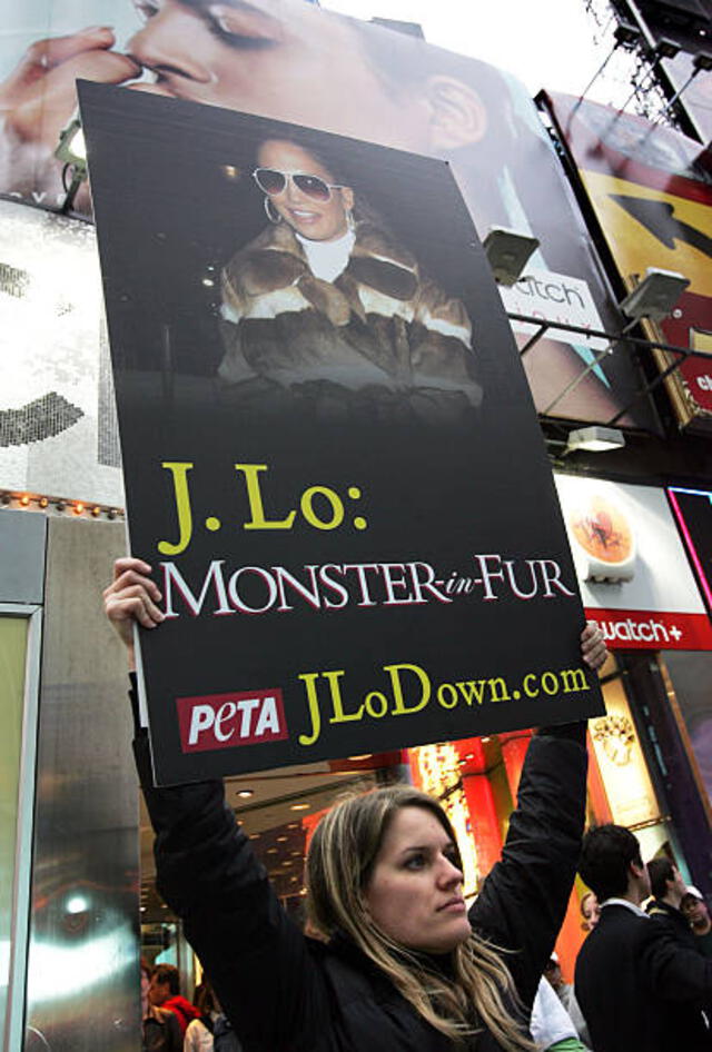 NEW YORK - MAY 2:  Anti-fur activists hold signs protesting Jennifer Lopez's use of fur in her clothing designs outside the MTV Studios during her appearance on TRL May 2, 2005 in New York City.  (Photo by Scott Gries/Getty Images)